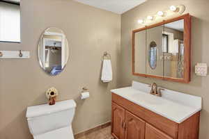 Bathroom featuring tile patterned floors, toilet, and vanity