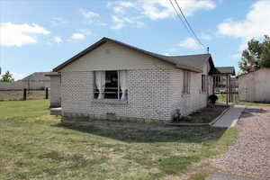 View of property exterior with a yard