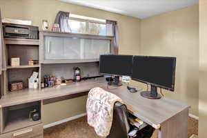 Office space with desk and carpet flooring