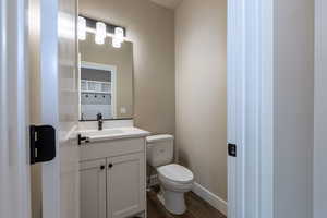 Bathroom featuring vanity, toilet, and hardwood / wood-style flooring