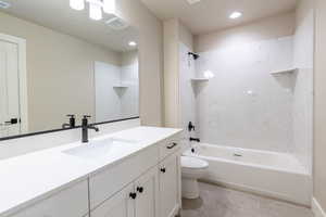 Full bathroom featuring tile patterned floors, tiled shower / bath, toilet, and vanity