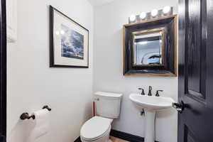 Bathroom featuring toilet and hardwood / wood-style flooring