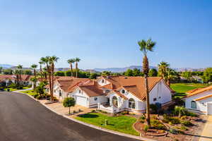 Mediterranean / spanish-style home with central AC, a mountain view, and a garage