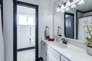 Bathroom with tile patterned flooring, toilet, and vanity