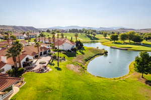 Birds eye view of property with a water and mountain view