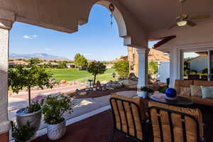 View of patio with a mountain view and ceiling fan