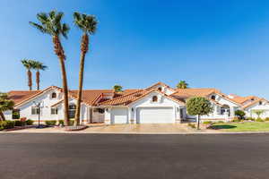 Mediterranean / spanish-style home with a garage