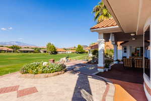 View of patio / terrace featuring a mountain view and ceiling fan