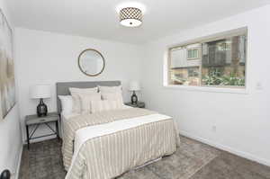 Bedroom featuring dark carpet