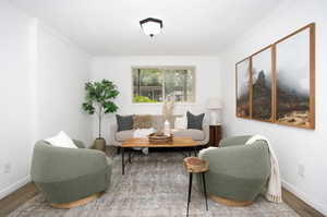 Sitting room featuring hardwood / wood-style floors and crown molding