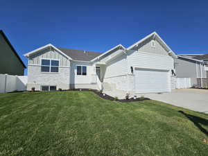 View of front of property with a front lawn and a garage