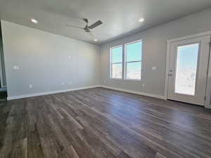 Spare room featuring a textured ceiling, ceiling fan, and dark hardwood / wood-style floors