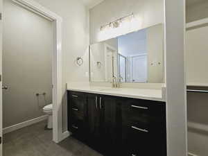 Bathroom with tile patterned flooring, vanity, and toilet