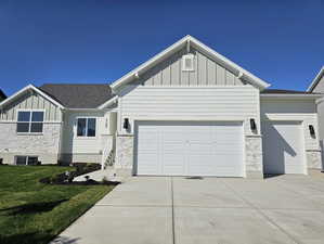 View of front of home with a garage and a front yard