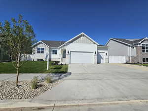 View of front of house with a garage and a front lawn