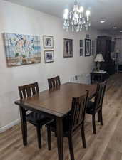 Dining area featuring hardwood / wood-style flooring and a notable chandelier