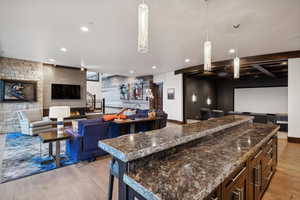 Kitchen featuring light wood-type flooring, hanging light fixtures, and a kitchen island