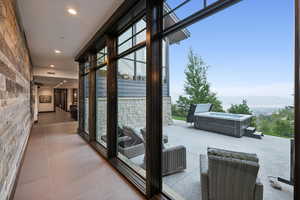 Doorway to outside featuring light tile patterned flooring