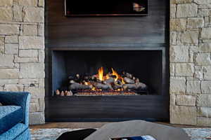 Interior details featuring a stone fireplace and hardwood / wood-style flooring