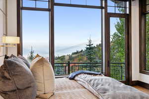 Bedroom with hardwood / wood-style floors and multiple windows