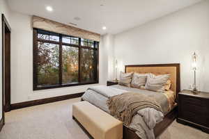 Bedroom with light colored carpet