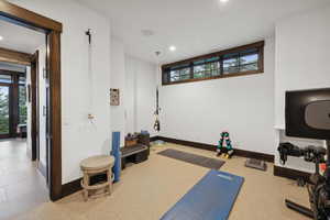 Workout area with a wealth of natural light and tile patterned floors