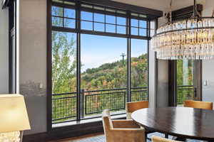 Dining room featuring floor to ceiling windows and hardwood / wood-style floors