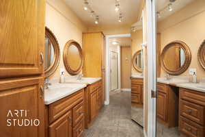 Bathroom featuring tile patterned floors, a shower with door, and vanity