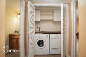 Laundry area featuring tile patterned flooring and separate washer and dryer