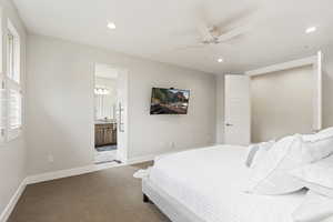 Bedroom featuring carpet flooring, ceiling fan, and ensuite bath