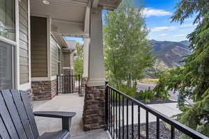 Balcony featuring a porch and a mountain view