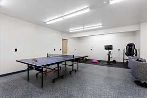 Game room with a textured ceiling