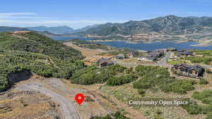 Drone / aerial view featuring a water and mountain view