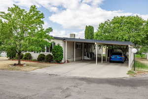 Ranch-style home featuring a carport