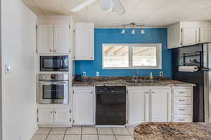 Kitchen featuring black appliances, ceiling fan, sink, and white cabinetry