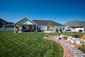 Rear exterior view of home with xeriscape.