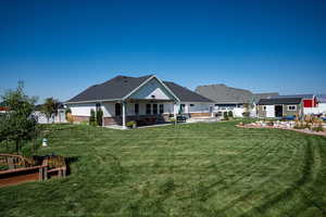 Rear view of property featuring garden boxes.