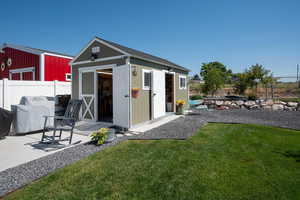 View of workshop with ramps. Big enough to house a golf cart or razor.