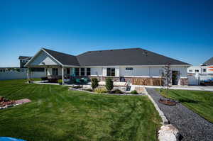 Rear view of property featuring xeriscape.