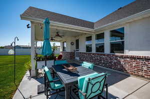 View of back patio / terrace with ceiling fan.