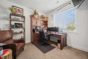 Office or bedroom with large front facing window.