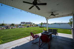 View of covered back patio with double fans.