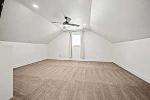 Bonus room with lofted ceiling, and ceiling fan.