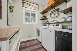 Laundry room featuring sliding barn door and hanging shelves.