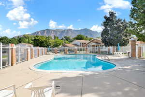 View of swimming pool with a mountain view and a patio area