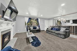 Living room with carpet and a textured ceiling