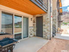 Property entrance featuring a patio area and a balcony