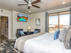 Bedroom featuring ceiling fan, hardwood / wood-style flooring, and access to outside