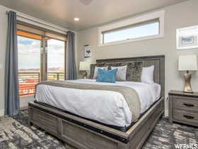 Bedroom featuring multiple windows and ceiling fan