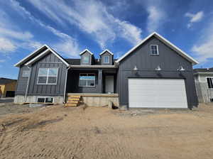 View of front facade with a garage and covered porch